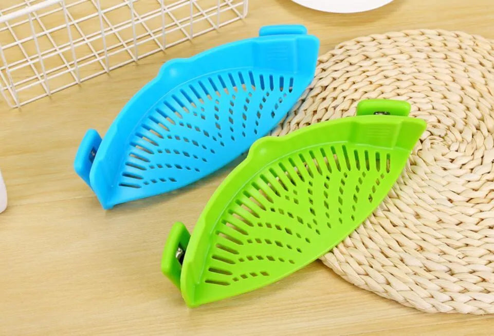 Silicone clip-on kitchen strainer attached to pot rim draining liquid