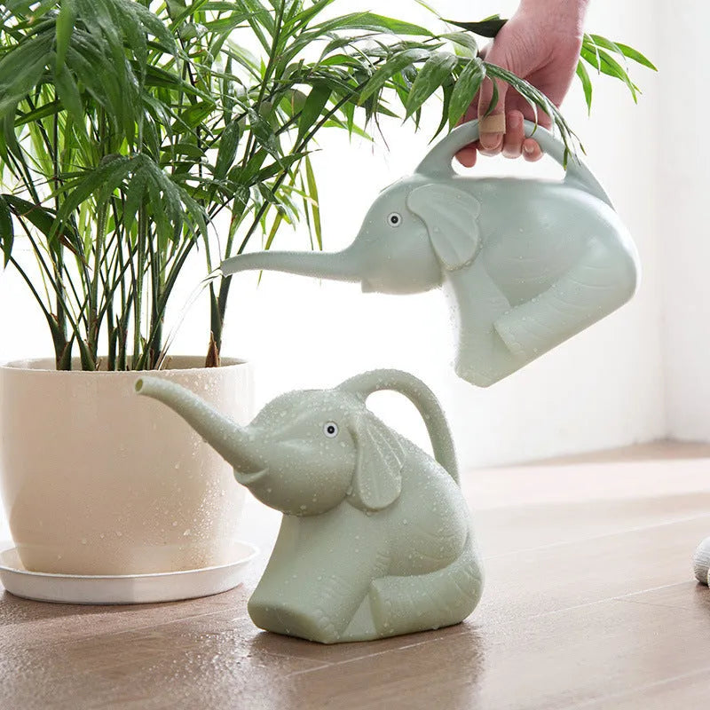 Pink plastic baby elephant-shaped watering can with a long nozzle and handle.