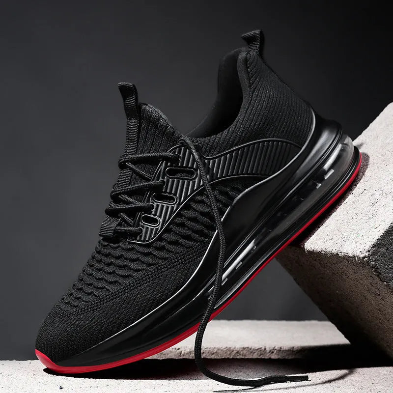 Men's black low-top lace-up running sneakers with mesh upper on a white background.