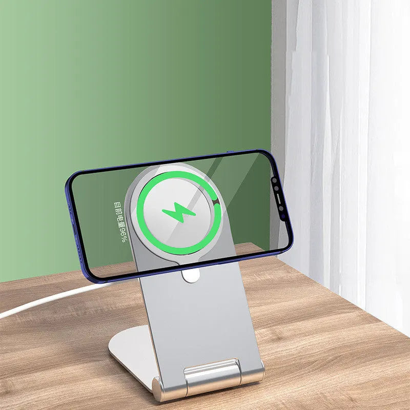 Silver vertical adjustable portable magnetic phone bracket on a metallic surface