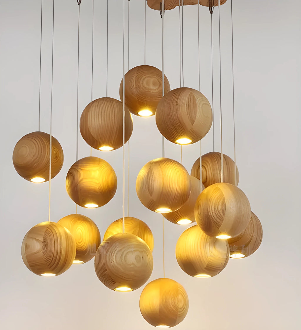 Nordic style solid wood ball chandelier pendant light hanging from ceiling on adjustable cord.