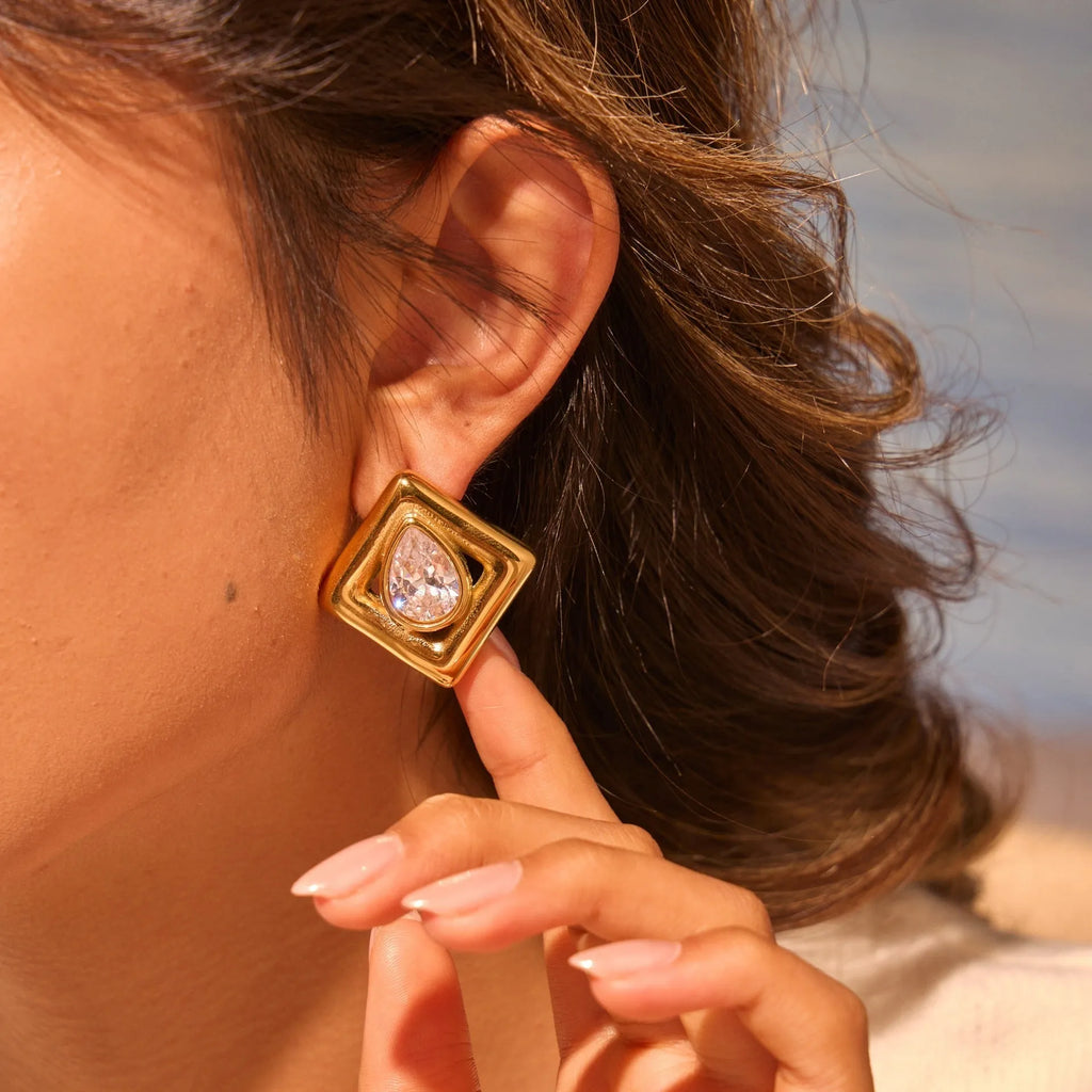 Gold-tone geometric stud earrings with inlaid water drop zircon stones on stainless steel