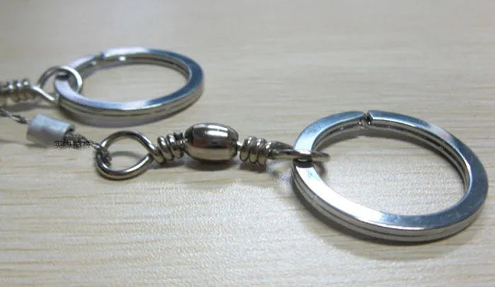 Survival wire saw with stainless steel blade, pull ring, and hoop handles for outdoor cutting