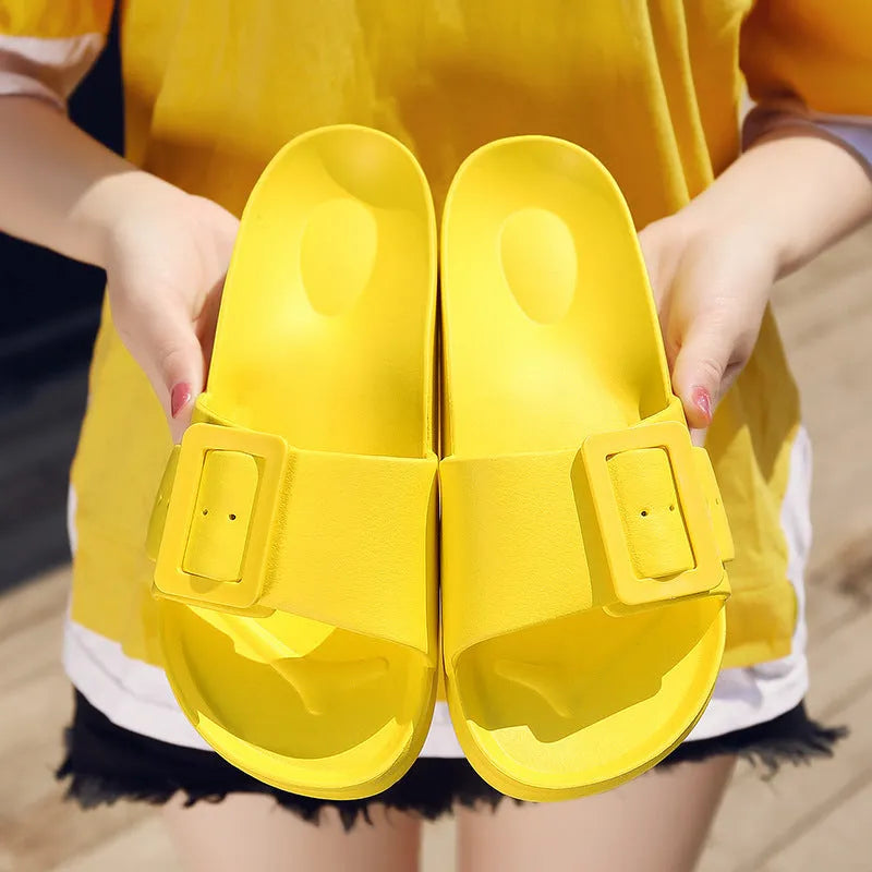 Women's grey blue flip-flop slippers with a buckle fastening on a white background