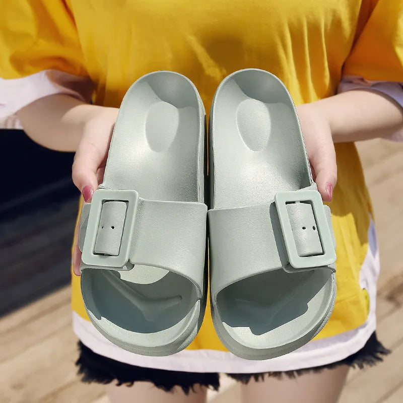 Women's grey blue flip-flop slippers with a buckle fastening on a white background