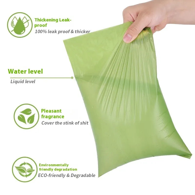 Roll of EPI degradable green dog poo bags next to a black portable dispenser on a green background.