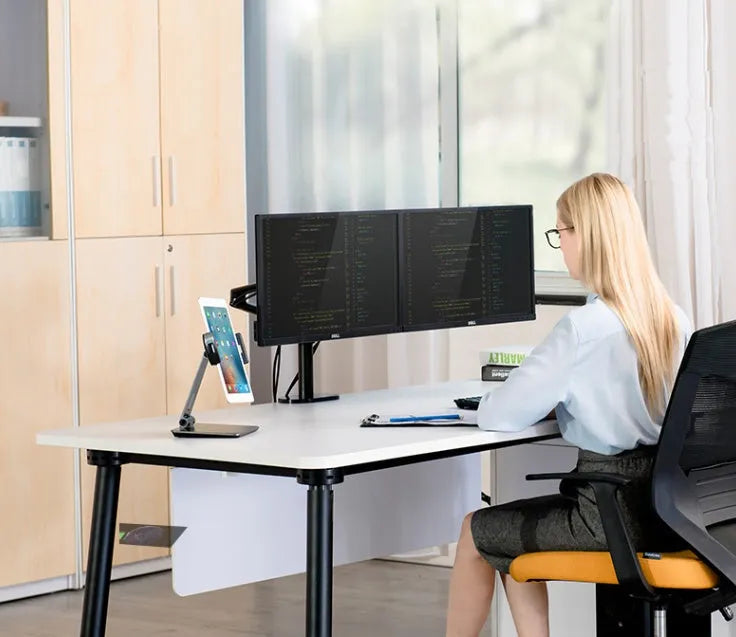 Black folding aluminium desktop stand holding a tablet at an angle, showing 360° rotation and silicone grips.
