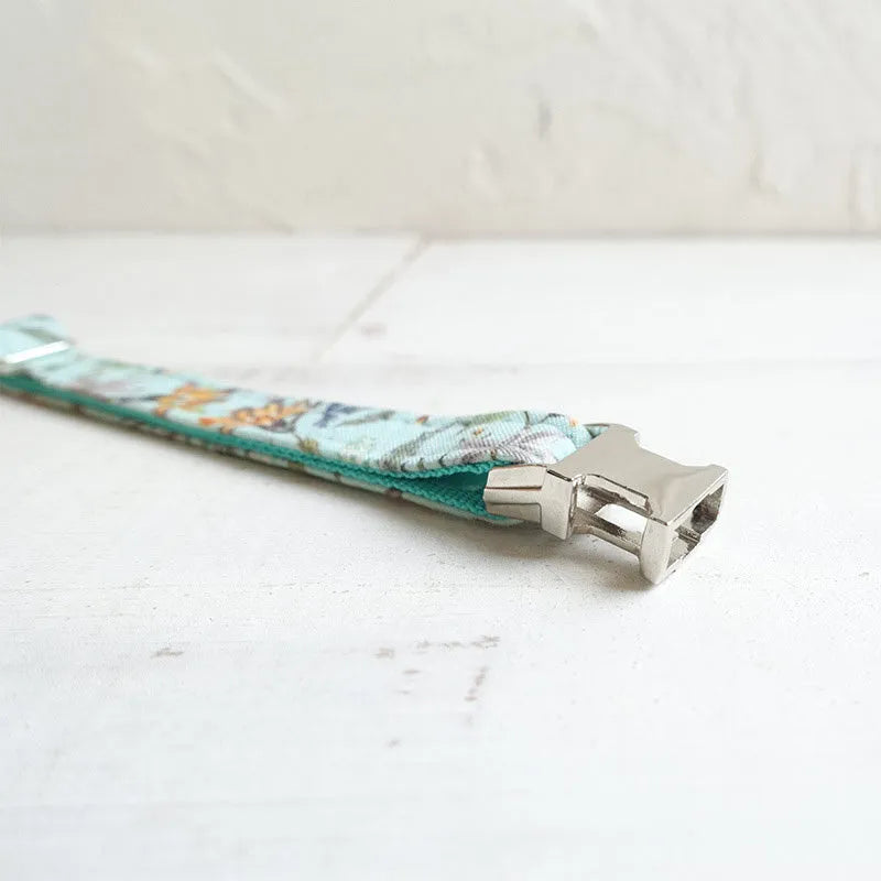 Green adjustable pet collar made from cloth and webbing, available in sizes L and S