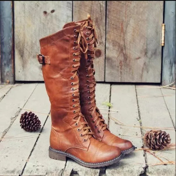 Women's black high leg boots with a chunky low heel and round toe on a plain background.