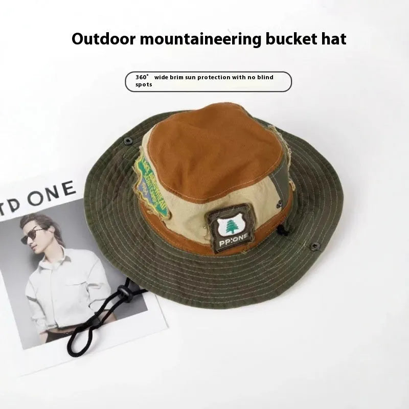 Army green cotton fisherman hat with patchwork detail and flat top crown on a neutral background.
