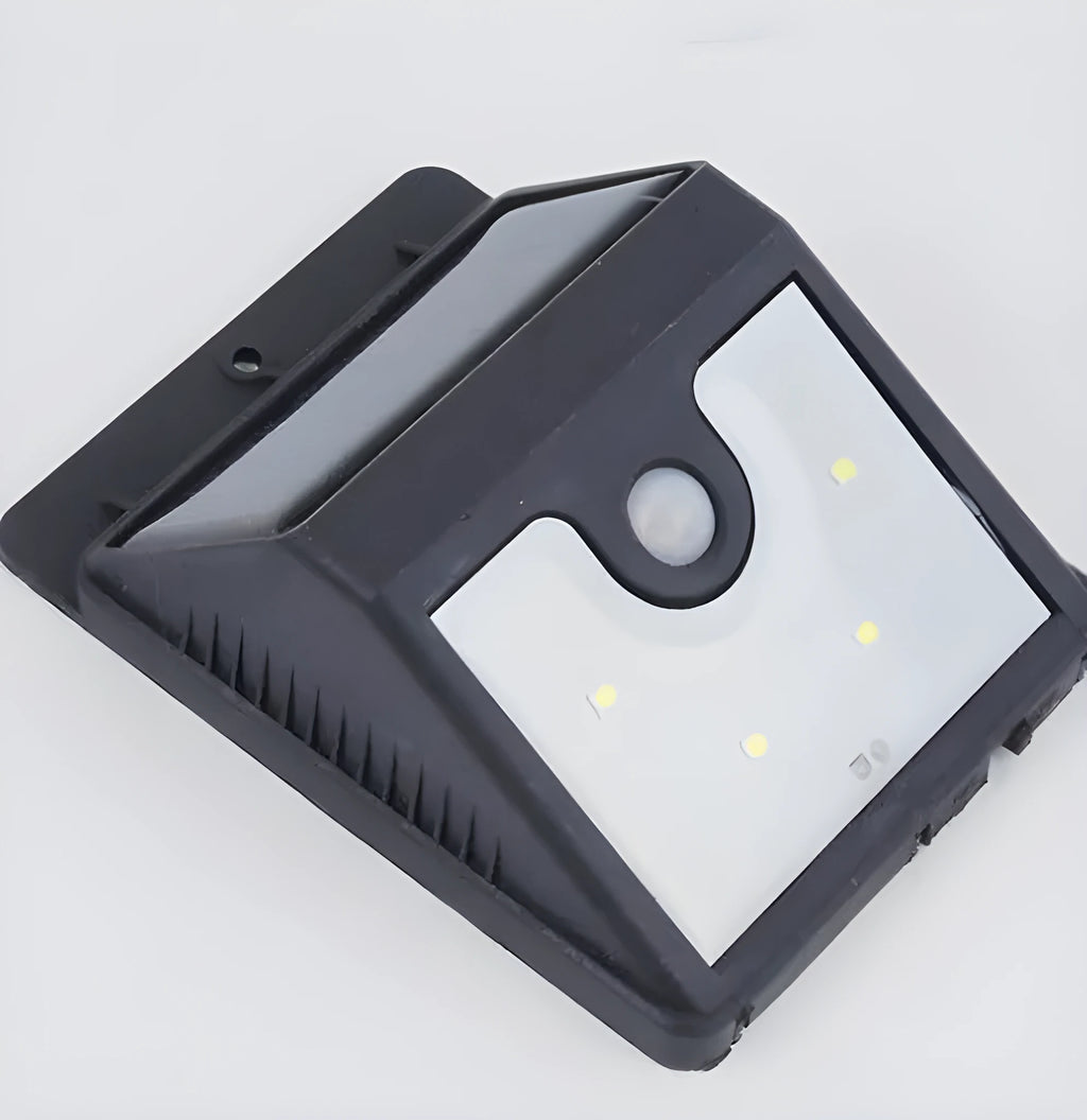 Black rectangular solar-powered outdoor motion sensor light with four LED bulbs.