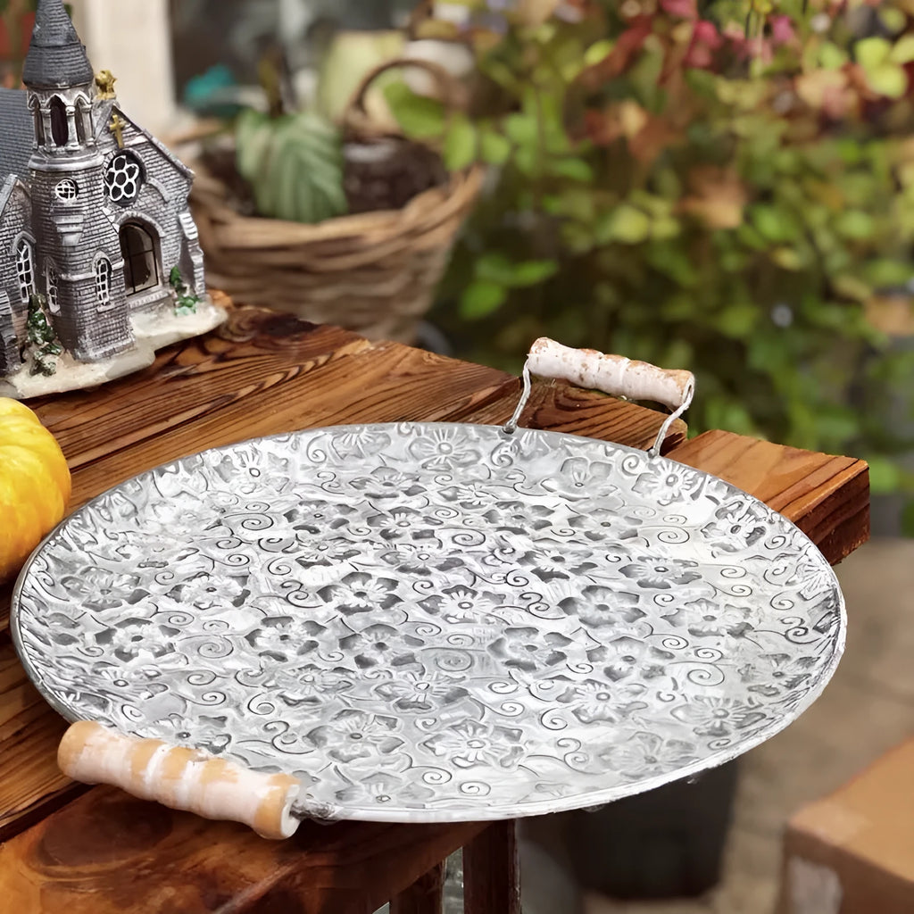 Round wrought iron storage tray in two sizes on a wooden surface