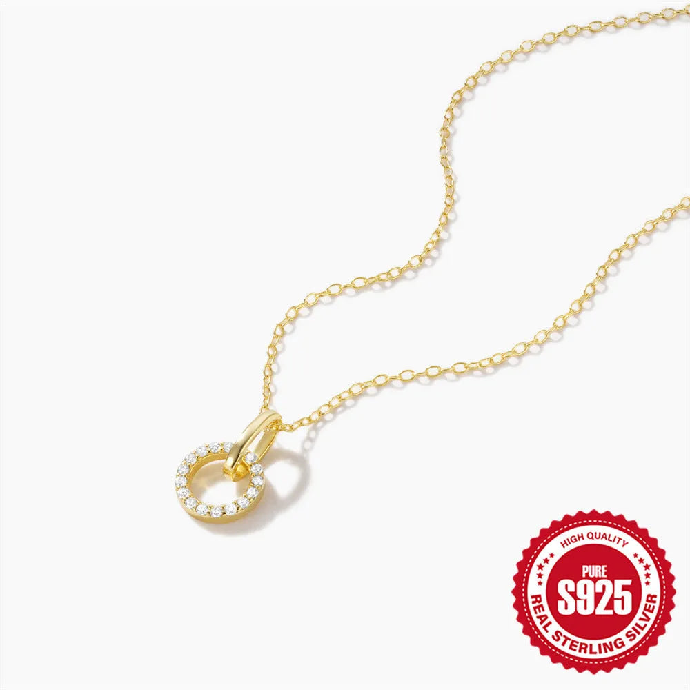 Gold-coloured sterling silver adjustable clavicle chain with interlocking geometric zircon pendant.