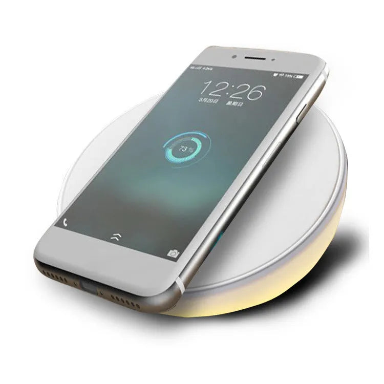 White QI wireless phone charger with digital clock display and three control buttons.