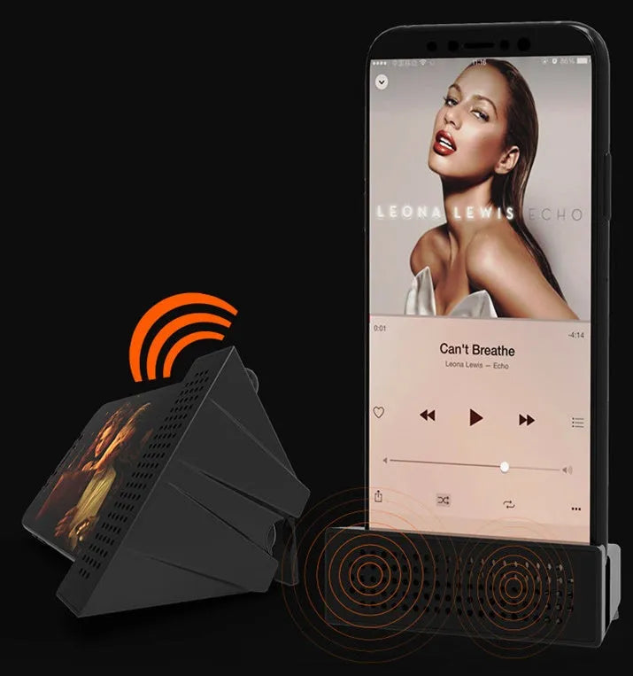 A small black plastic phone amplifier stand holding a smartphone on a desktop.