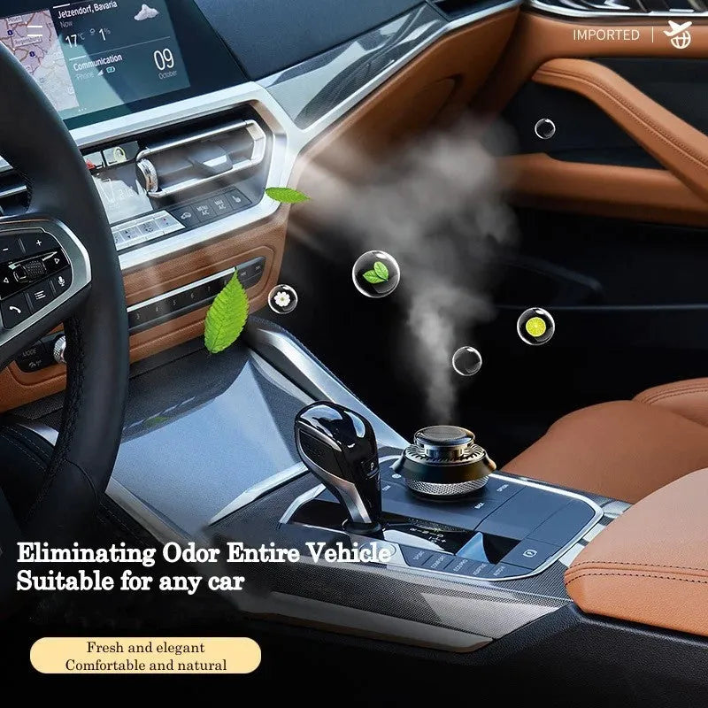 Solar-powered kinetic car air freshener with rotating double rings on a black dashboard.