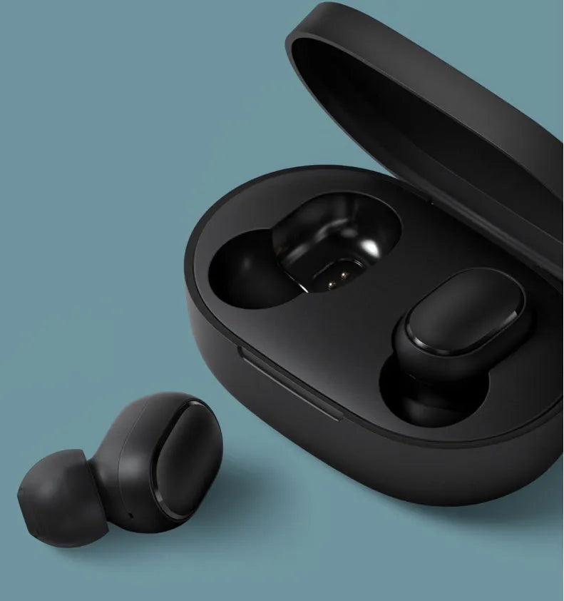Redmi AirDots black true wireless earbuds next to their compact white charging case.