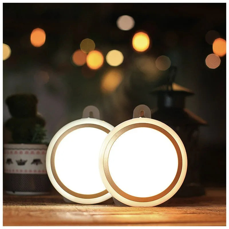 Circular white motion sensor LED light with five LEDs, shown mounted inside a dark wardrobe.