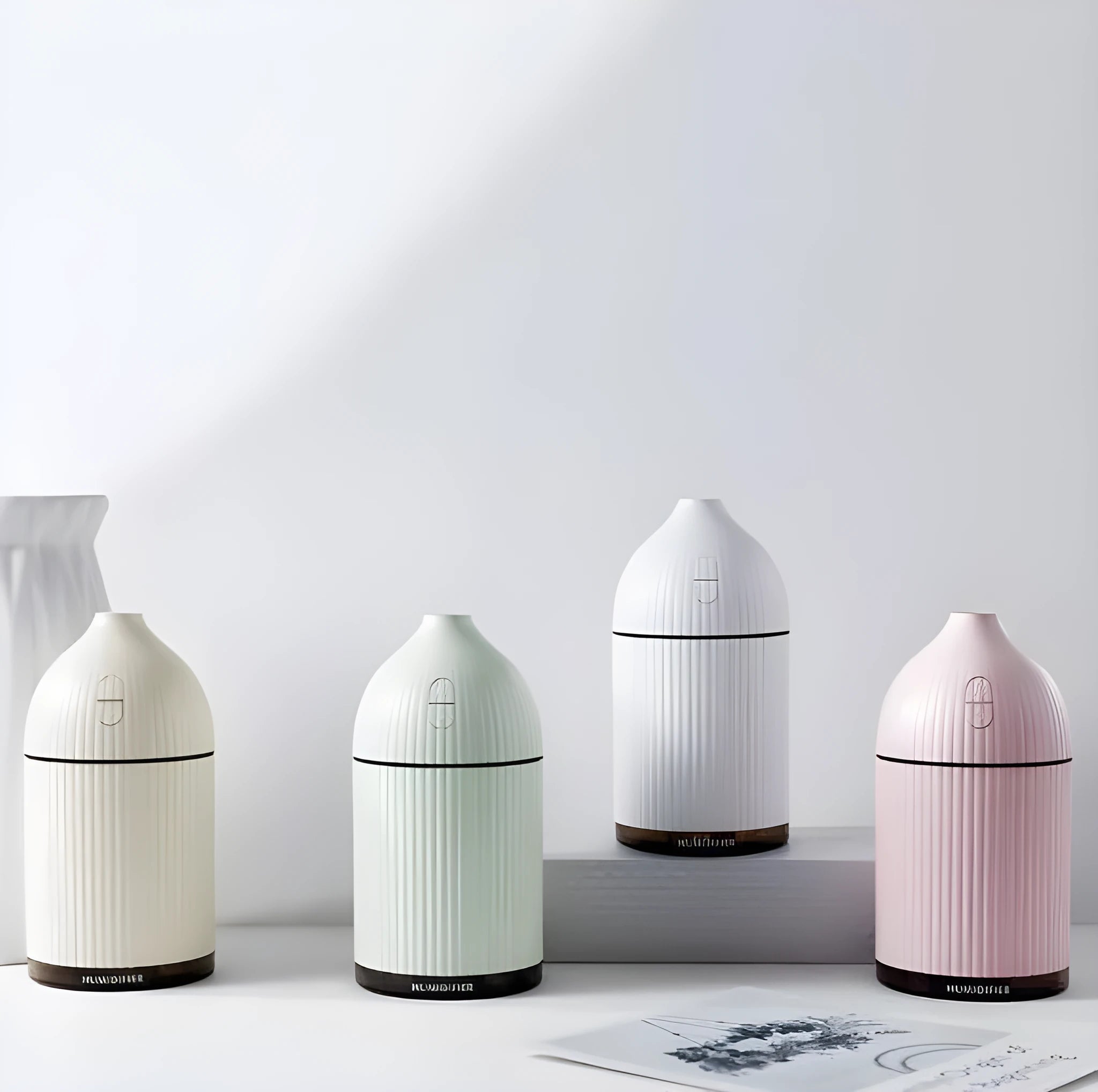 White ultrasonic aromatherapy diffuser with LED light and 300ml water capacity, measuring 80x80x155mm
