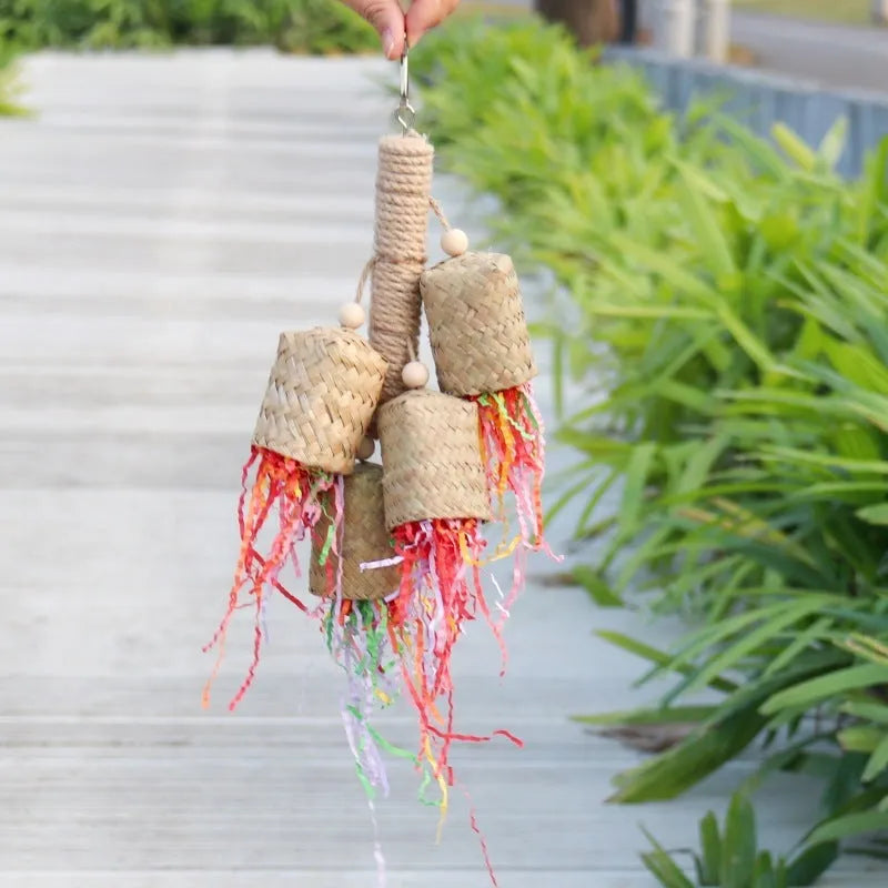 Colourful shredded paper hanging bird toy made of wood and sisal for parrots.