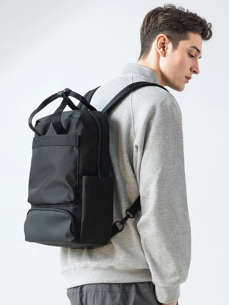 Black Oxford cloth computer backpack with a polyester lining, showing storage compartments.