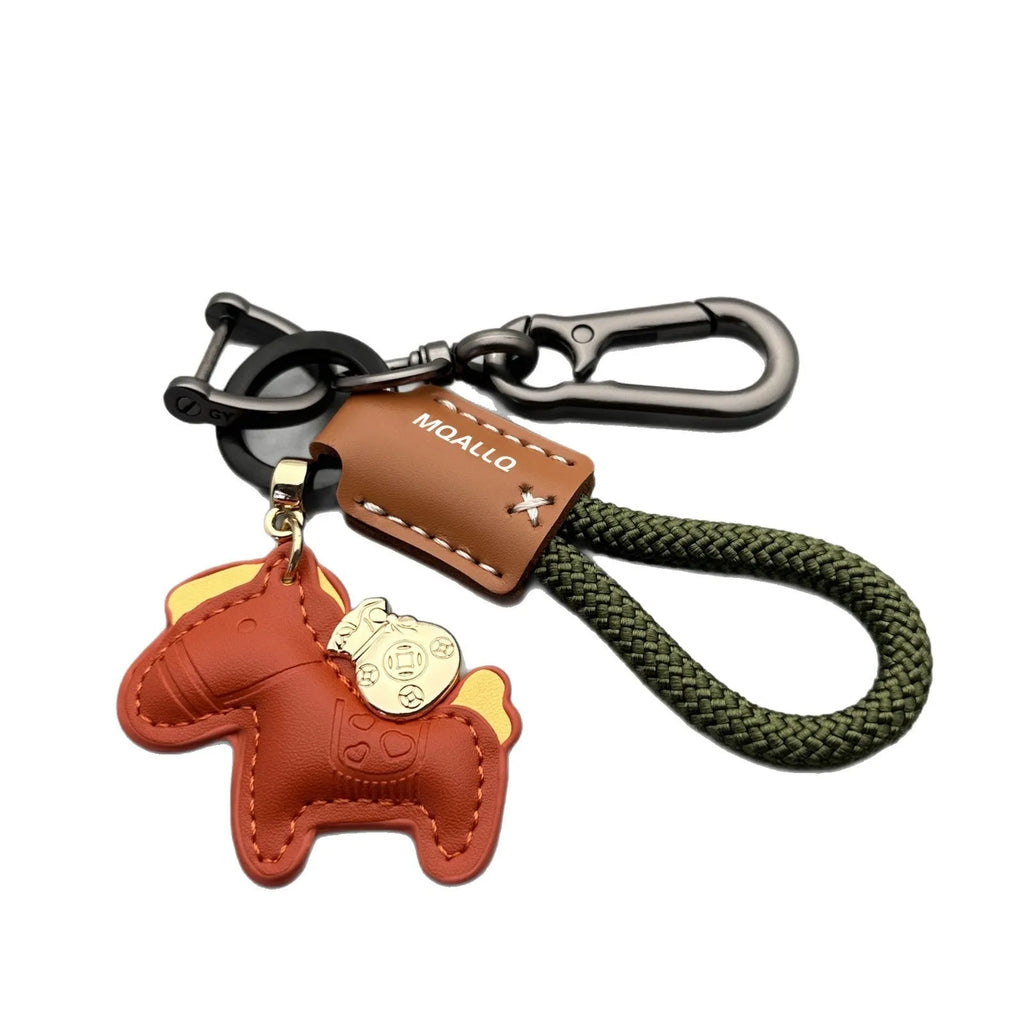 Handmade cowhide car keychain pendant with a zinc alloy pony buckle and coloured flanelle rope strap.