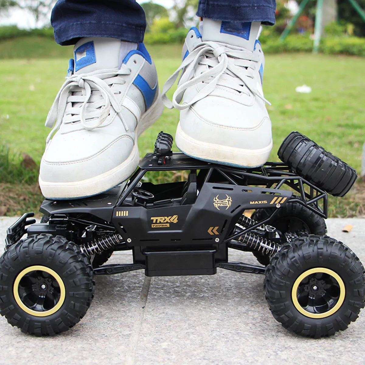 Black and silver 2.4G wireless remote control off-road cars in 28cm and 37cm sizes on rough terrain