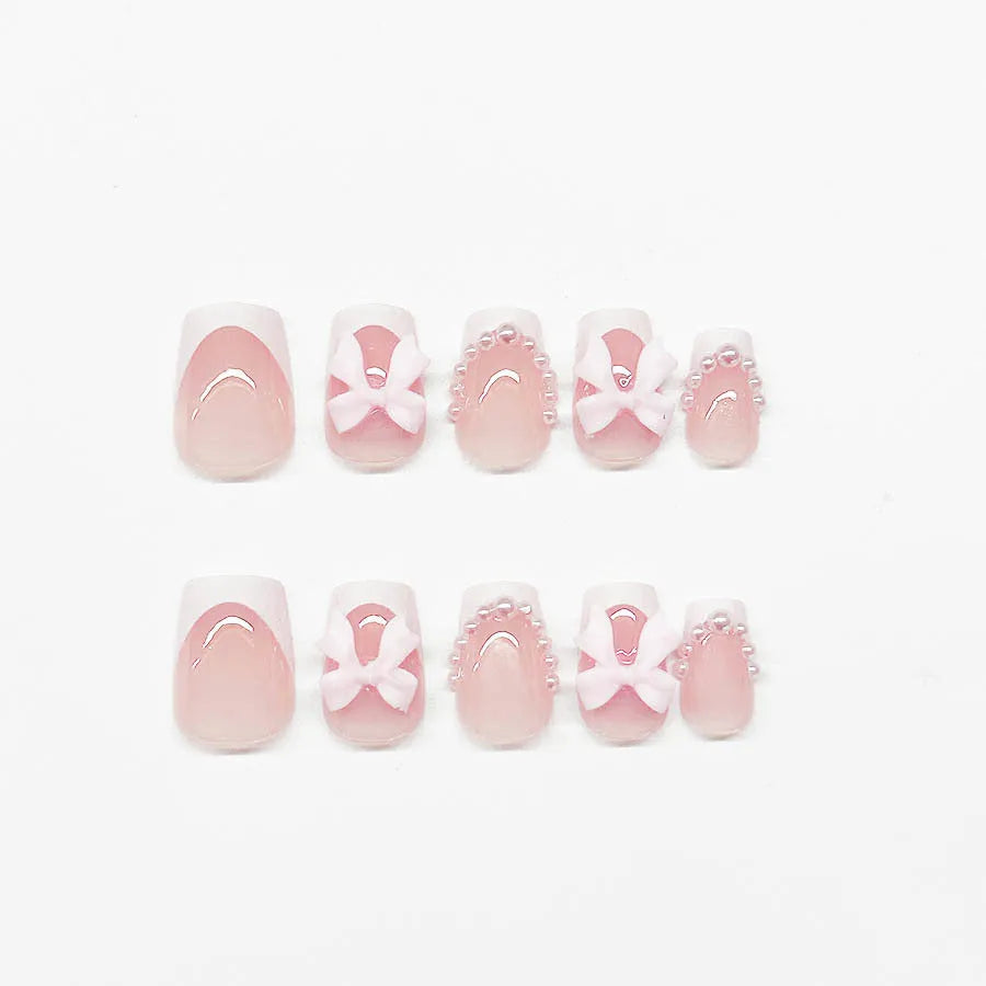 Set of short white French manicure nail art stickers showing bow, tulip, starry sky, and leopard print patterns.
