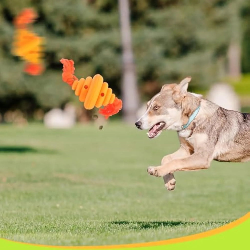 Green and yellow silicone dog ball with integrated rope, shown as a food-dispensing chew and tug toy.