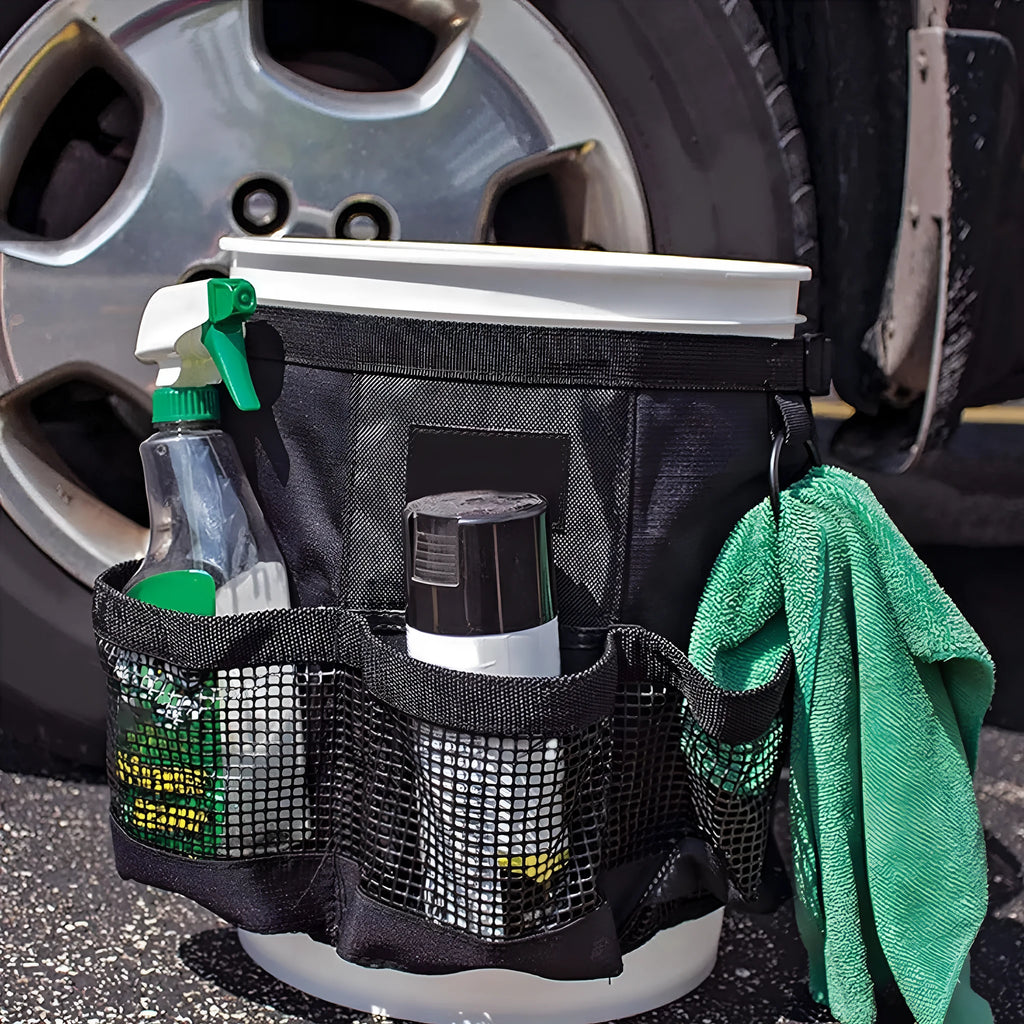 Black cylindrical polyester buggy bag hanging from a 5 gallon barrel for tool storage.