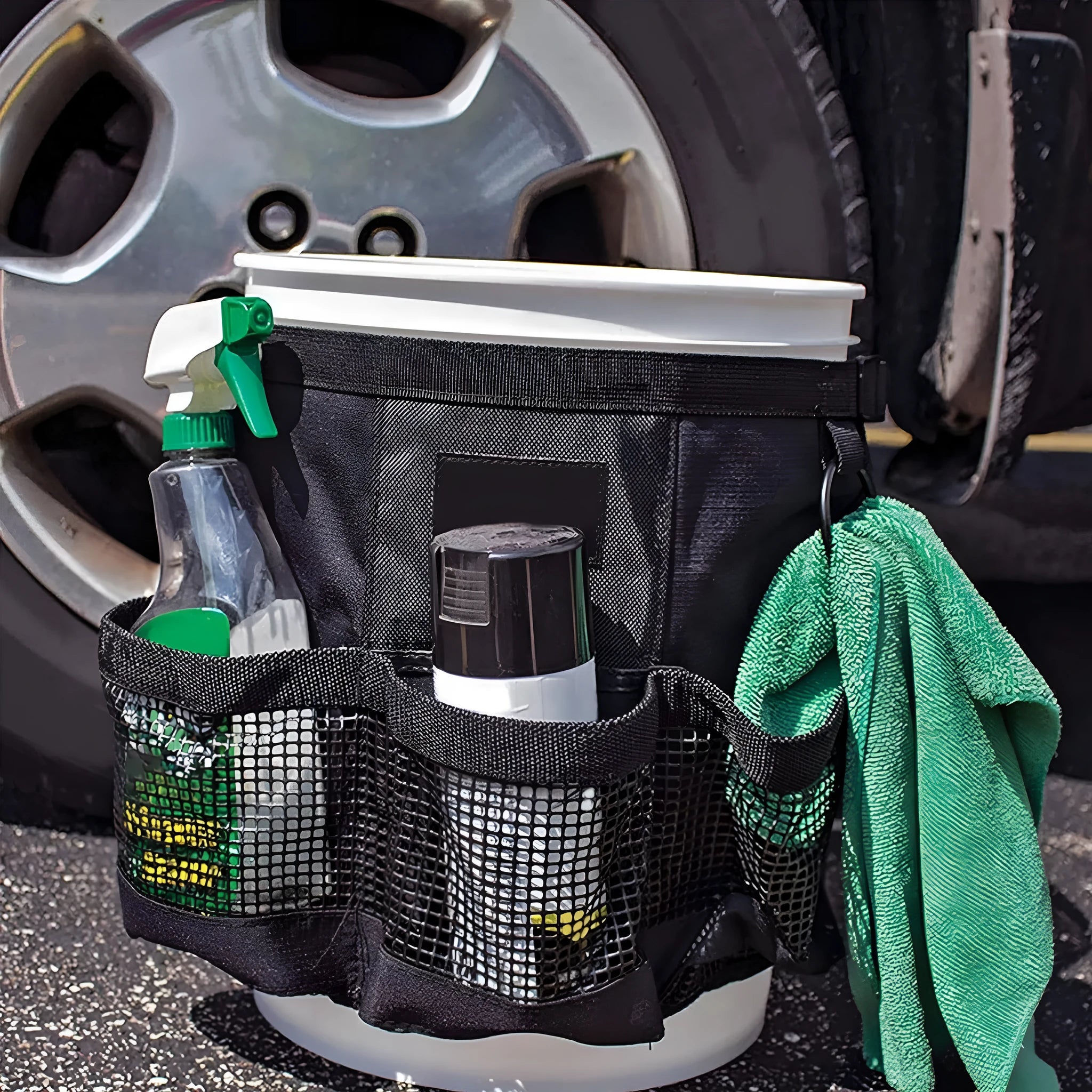 Black cylindrical polyester buggy bag hanging from a 5 gallon barrel for tool storage.