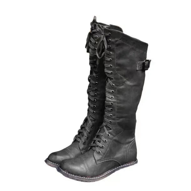 Women's black high leg boots with a chunky low heel and round toe on a plain background.