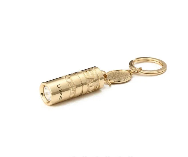 Gold zinc alloy LED flashlight attached to a keyring for outdoor and emergency use.