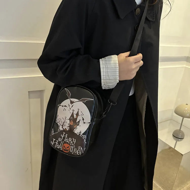 Halloween graffiti crossbody phone bag with cartoon pumpkin, ghost, and bat print in black.