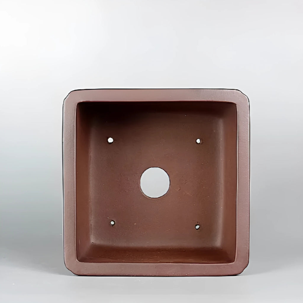 Brown handmade antique purple clay flower pot with classical styling.
