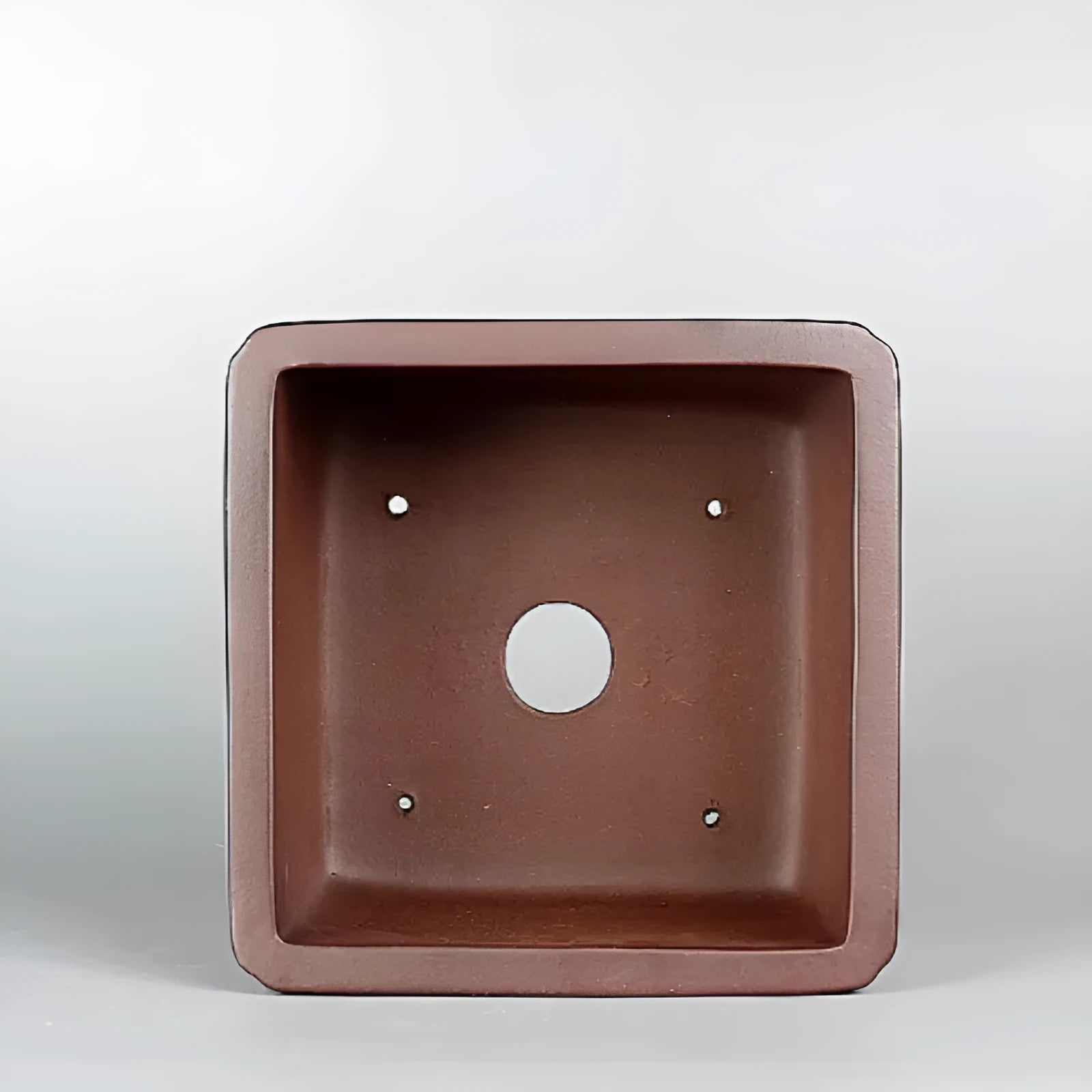 Brown handmade antique purple clay flower pot with classical styling.