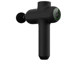 Black rechargeable massage gun with six different coloured massage heads laid out beside it.