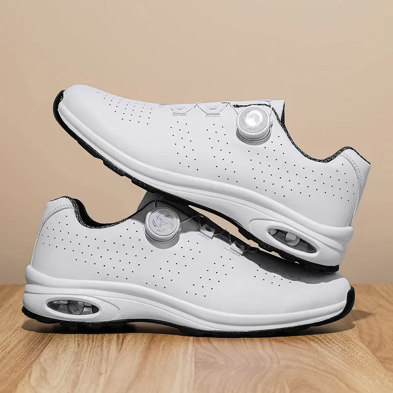 Black and white low top casual shoes with mesh upper, composite sole, and cross shoulder straps