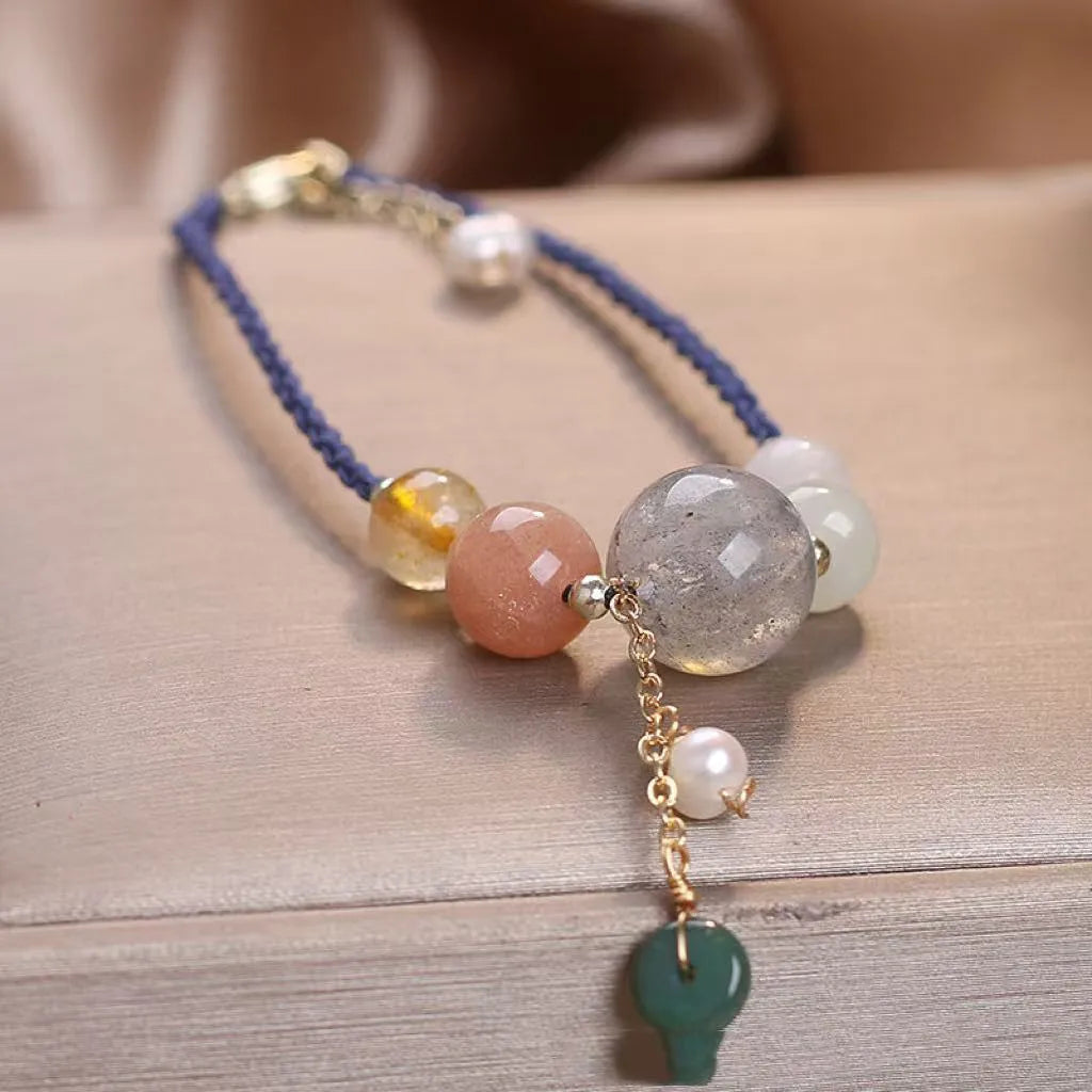 Hand-woven women's bracelet with peace buckle, crystal and sequin accents in red, green and blue colour options