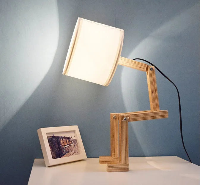 Creative small humanoid wooden table lamp with white fabric shade, 22x44x16cm, on bedside table