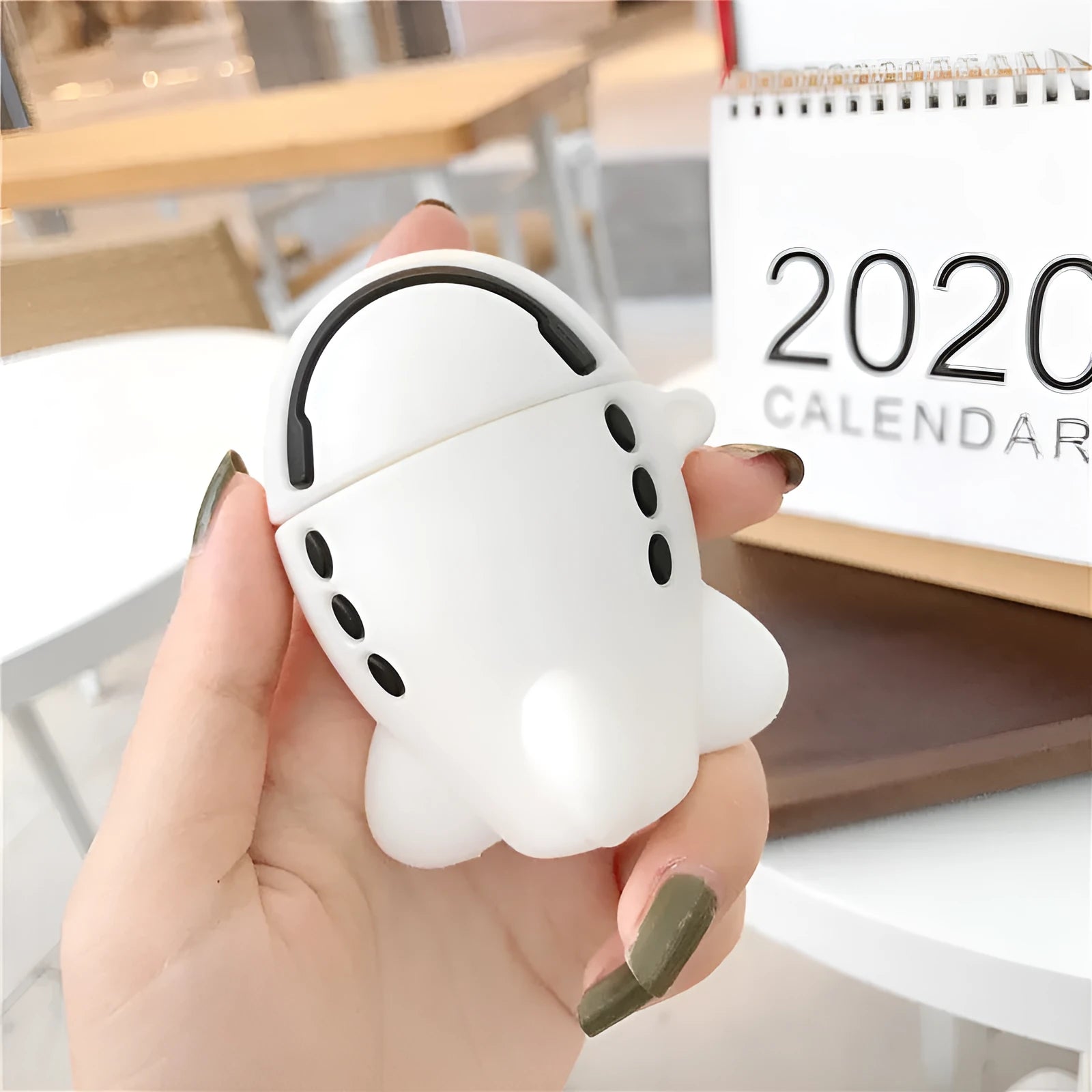 Silicone flip case for AirPods 1 and 2 with cartoon aeroplane headset design and metal hook.
