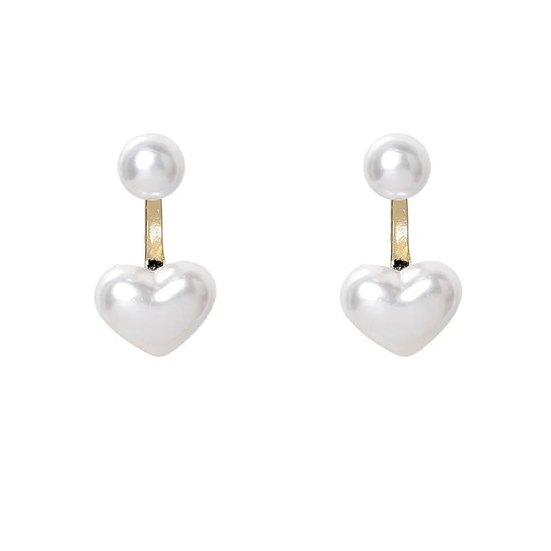 Women's heart-shaped stud earrings with a pearl-like centre in electroplated alloy, Korean style.