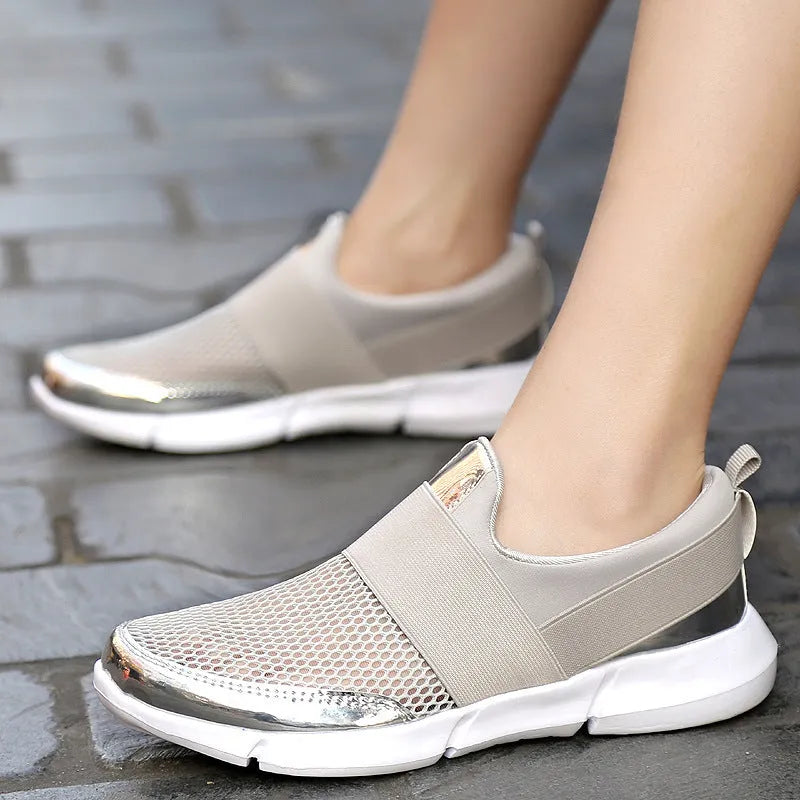 Women's low-top casual sneaker in grey with breathable mesh upper and lightweight sole.