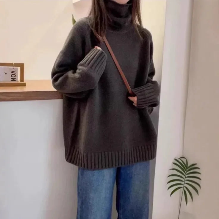 Women's loose black turtleneck sweater with a thick curling pile collar, casual style.