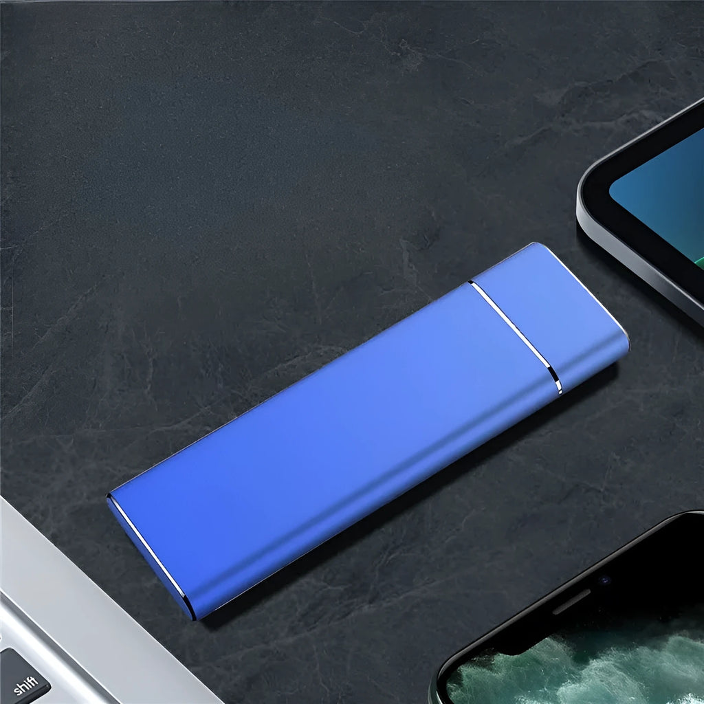Sapphire blue metal external hard drive with USB cable on a white surface.