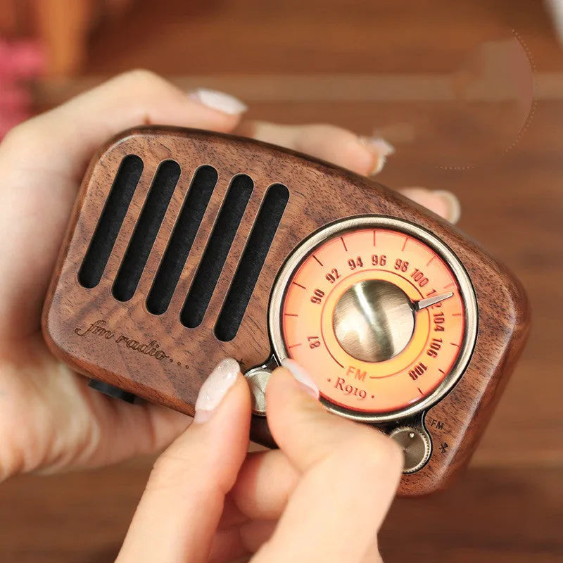 Retro wooden wireless mini speaker showing wood grain texture and compact size