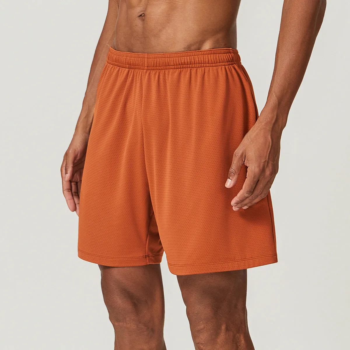 Man wearing sky blue double-layer quick-dry running shorts with a mid-waist fit.