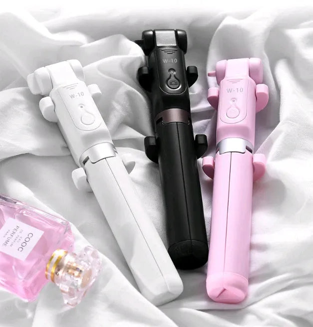 Black aluminium alloy Bluetooth selfie stick with tripod bracket extended, holding smartphone