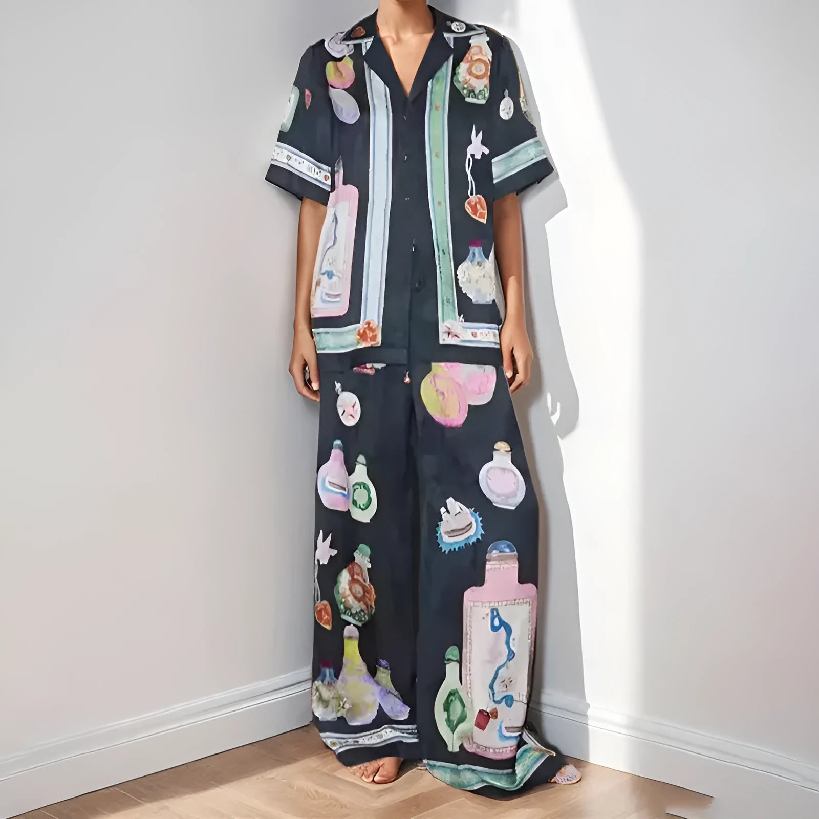 Black women's cardigan and trousers co-ord set with a cartoon pattern print.