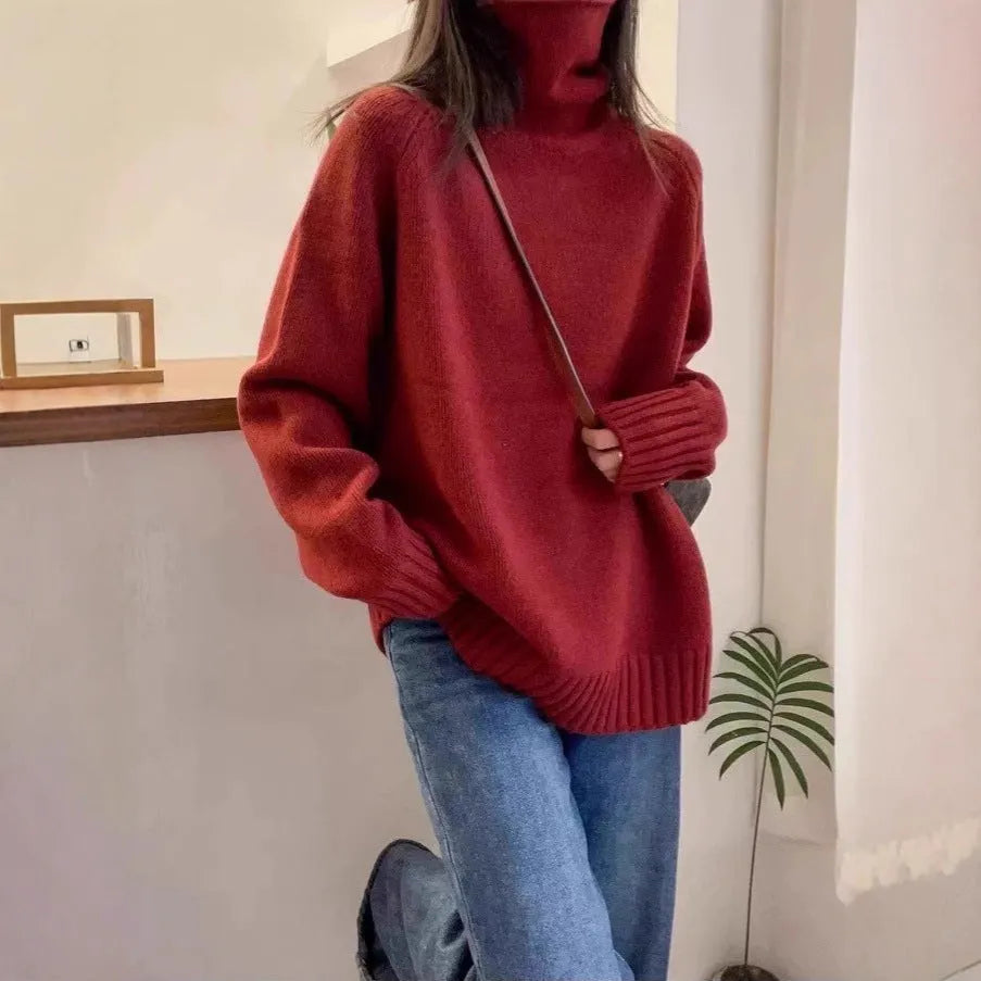 Women's loose black turtleneck sweater with a thick curling pile collar, casual style.